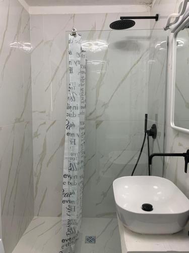 a white bathroom with a sink and a toilet at A Casa di JO in Bari
