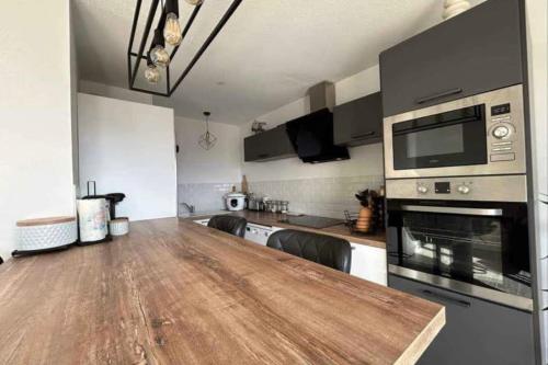 - une cuisine avec une grande table en bois dans l'établissement the cozy center, à Frontignan