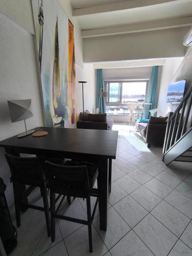 un salon avec une table et un canapé dans l'établissement Cap d'Agde Vue Port et Mer Parking Terrasse la Désirade, au Cap d'Agde
