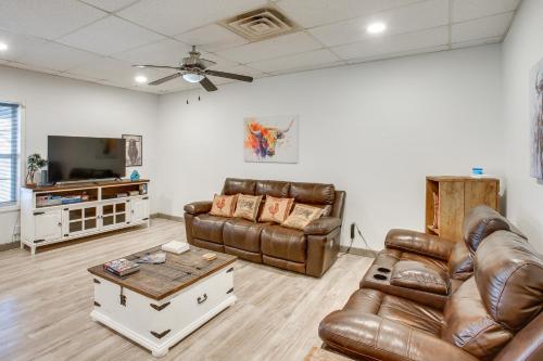 a living room with leather furniture and a flat screen tv at 8 Mi to Kentucky Downs Quiet Getaway with Patio in Portland