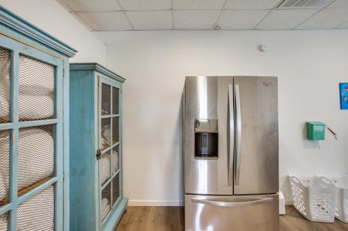 a stainless steel refrigerator in a room with a blue cabinet at 8 Mi to Kentucky Downs Quiet Getaway with Patio in Portland