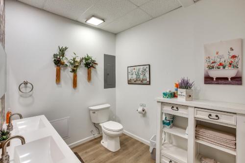 a white bathroom with a toilet and a sink at 8 Mi to Kentucky Downs Quiet Getaway with Patio in Portland