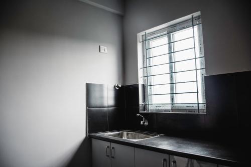 a kitchen with a sink and a window at Vivaan Comforts in Bidadi