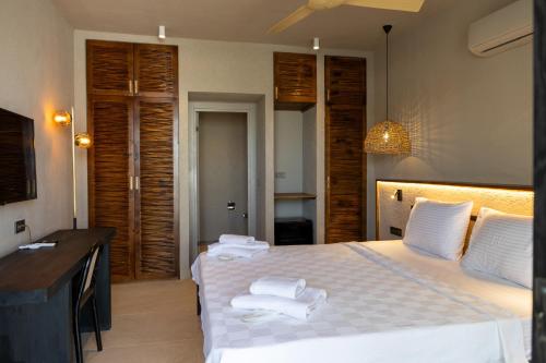 a bedroom with a bed with towels on it at Sea Soul Hotel in Bodrum City