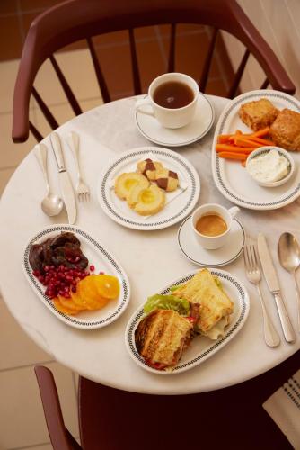 a white table with plates of food on it at Stockholm Stadshotell in Stockholm