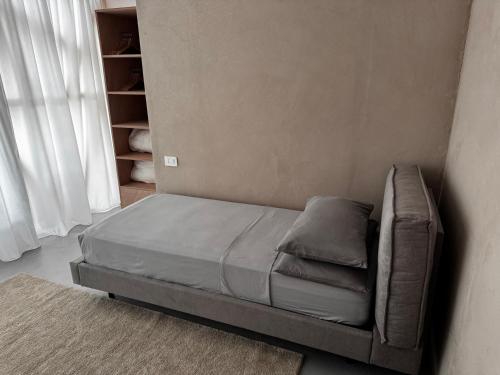 a bed sitting in a corner of a room at Agriturismo Voeuja Lago Maggiore in Luino