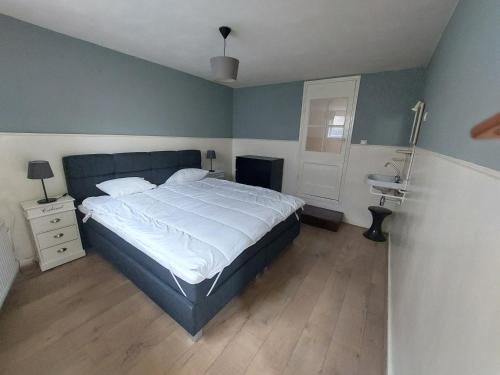 a bedroom with a large bed and a sink at Cosy appartment in Arnhem