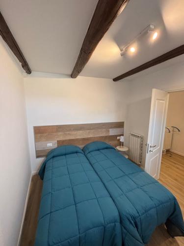 a bedroom with a large blue bed in a room at Casa Marí in Montefiascone