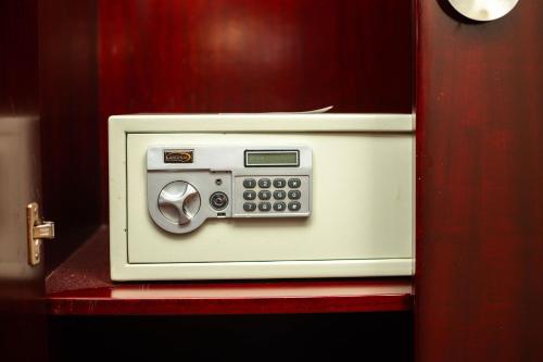 a white microwave sitting on top of a red shelf at Lancaster Kumasi City in Kumasi