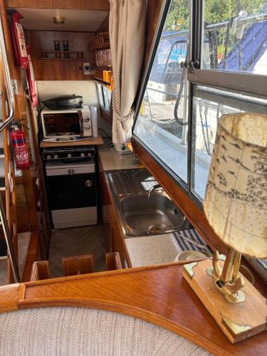 a kitchen with a stove and a sink in an rv at Floating tranquility in Dorney