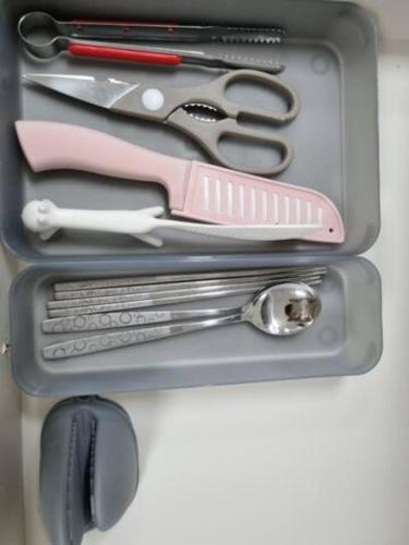 a group of kitchen utensils in a metal container at Yeosu UTOP UBLESS All Rooms Stunning Ocean View in Yeosu