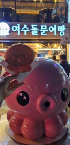a pink pig with two donuts on top of it at Yeosu UTOP UBLESS All Rooms Stunning Ocean View in Yeosu