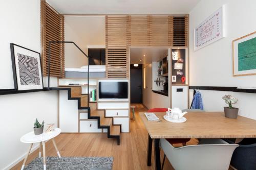 a living room filled with furniture and a table at Zoku Amsterdam in Amsterdam