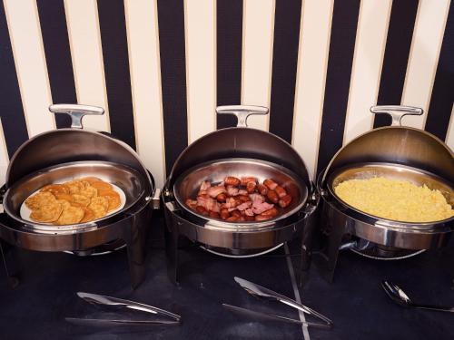 three pans of food on a stove with food in them at Garrigae Domaine de l'Esterel - piscine & SPA Cinq Mondes in Saint-Raphaël