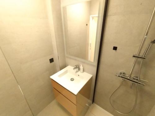 une salle de bain blanche avec un lavabo et une douche dans l'établissement Cozy 3 bedrooms, 5 mn 450m walk Metro La Defense, à Courbevoie