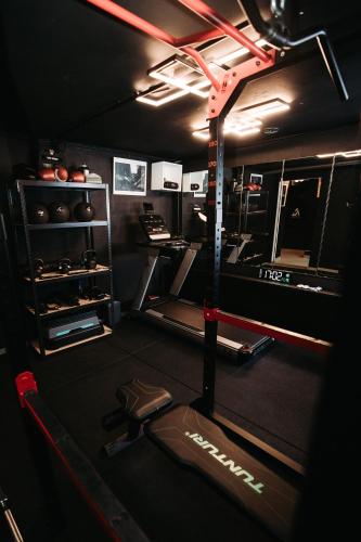 a room with a gym with a treadmill and weights at Pétrusse Élite Suites in Luxembourg