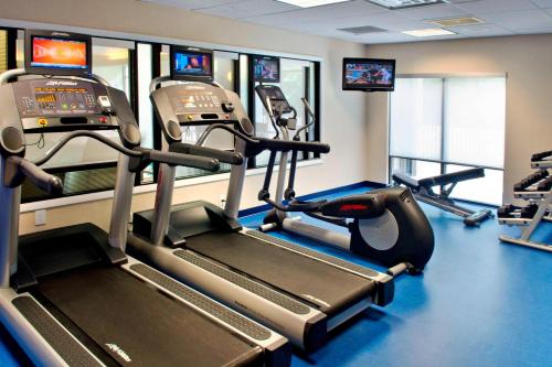 a gym with two tread machines and two televisions at SpringHill Suites Boston Andover in Andover