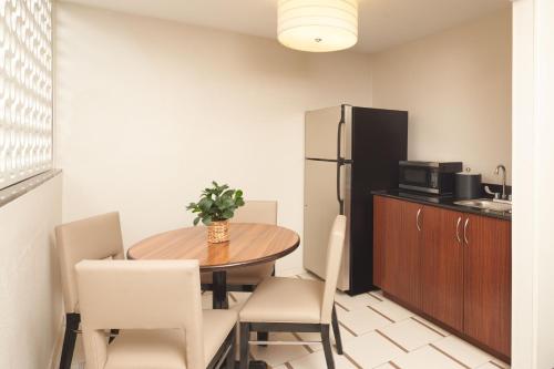 a dining room with a table and chairs and a refrigerator at Fairfield Inn & Suites by Marriott Orlando International Drive/Convention Center in Orlando