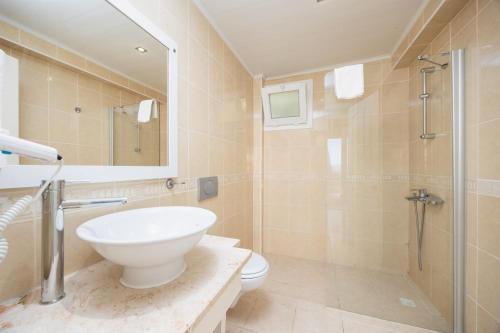 Un baño con lavabo, inodoro y ducha. en Golden Heights 15, en Ölüdeniz