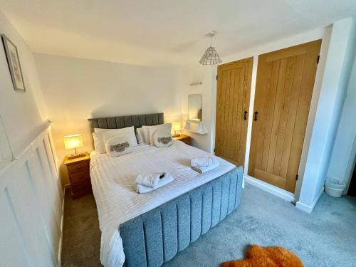 a bedroom with a bed with two towels on it at Swingletree Cottage in Bridlington