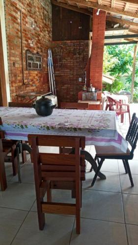 a table with a quilt on top of it at Casa com Jacuzzi em Itapoa, 400m da Praia Aceita Pets in Itapoa