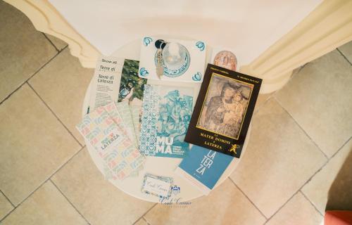 a table with a book and a picture on it at Conte Cavour - casa vacanze in Laterza