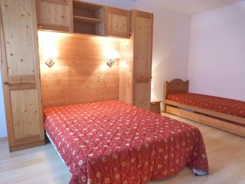 une chambre avec un lit avec une couette rouge dans l'établissement Grand duplex 2 pièces avec WiFi et animaux admis - FR-1-512-153, à Brides-les-Bains