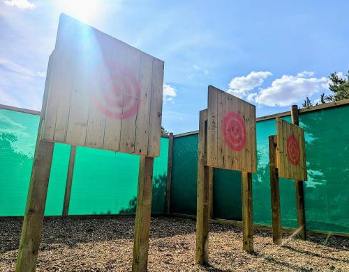 a group of wooden signs in front of a fence at Billing Aquadrome Holiday Park in Great Billing