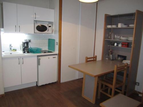 - une petite cuisine avec une table, une table et un comptoir dans l'établissement Studio 4 Pers. - Centre, Balcon, Parking, Wifi, 200m Télécabine - FR-1-512-113, à Brides-les-Bains