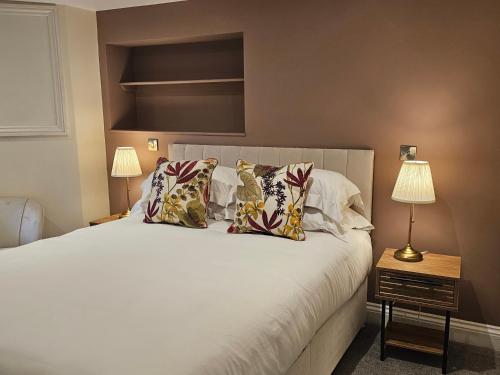 a bedroom with a large white bed with pillows at St George's Guest House in York
