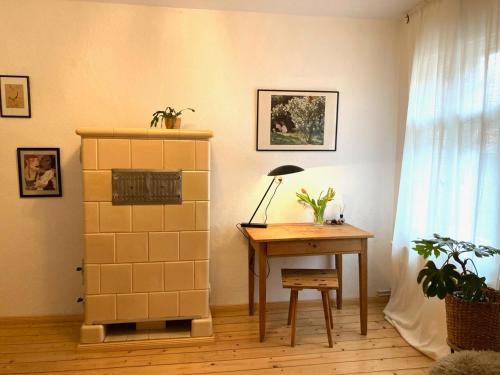 a room with a desk and a fireplace and a table at Gästehaus Schlamau19 in Schlamau