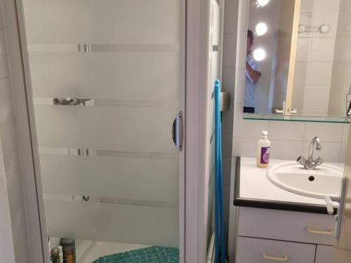 un homme prenant une photo d'une salle de bains avec lavabo dans l'établissement Appartement Duplex Climatisé, Quartier Richelieu, Proche Plages, Garage, Cap d'Agde - FR-1-749-18, à Agde