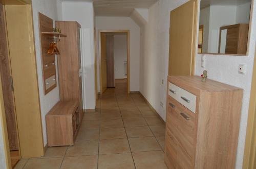 a room with a kitchen with a counter and a hallway at Ferienwohnung Gabler in Landsberg am Lech