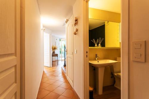 a bathroom with a sink and a toilet and yellow cabinets at VILLA LUNA VI4339 By Riviera Holiday Homes in Èze
