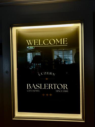 a window of a building with the words welcome to a berrierartment at ROESLI Guest House in Luzern
