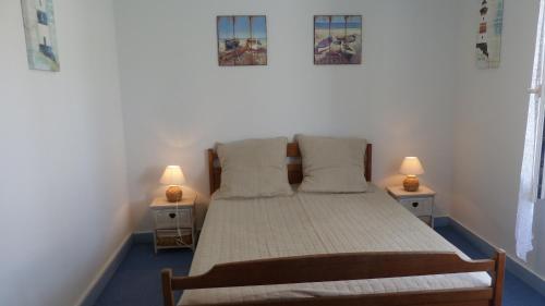 une chambre avec un lit avec deux lampes sur deux tables dans l'établissement TY ME ZA - Maison jardin St Colomban - C143, à Carnac