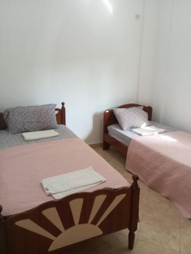 two beds sitting next to each other in a room at Apartments Salai in Lukovë