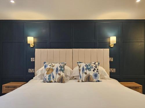 a bedroom with a large bed with two pillows at St George's Guest House in York