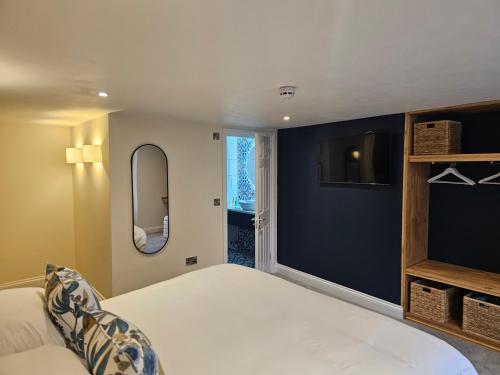 a bedroom with a white bed and a blue wall at St George's Guest House in York