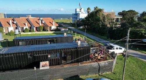 a group of people standing on the side of a train at Apart Containers, Acantilados in Mar del Plata