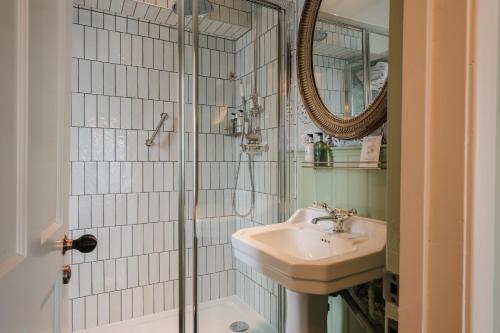 a bathroom with a sink and a shower at The Manor House Hotel in Moreton in Marsh