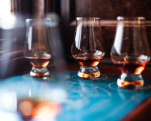 three glasses of whiskey sitting on top of a table at Rooiheuwel in Botrivier