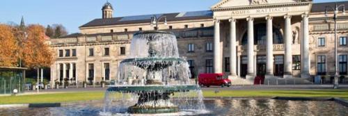 a water fountain in front of a large building at Hotel am Landeshaus in Wiesbaden