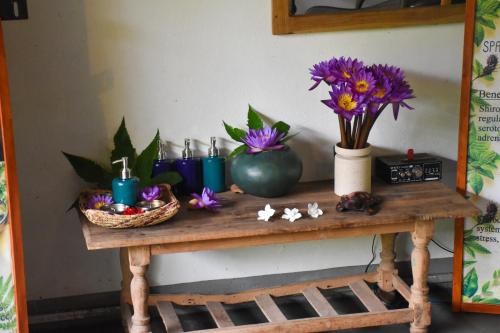 a table with flowers and candles on it at Cinnamon Mantra Luxury Villa in Beruwala