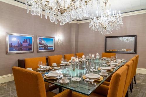 a dining room with a long table and chairs at The Capital Suites Hotel in Columbus