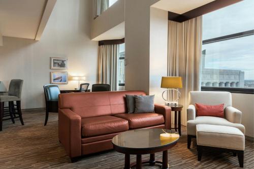 a living room with a couch and a chair at The Capital Suites Hotel in Columbus