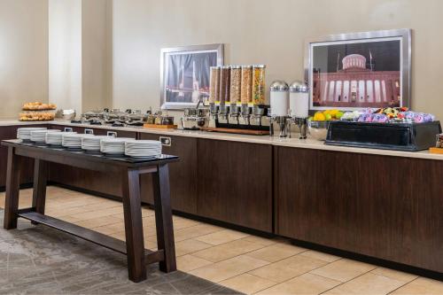 a buffet line with a table with plates of food at The Capital Suites Hotel in Columbus