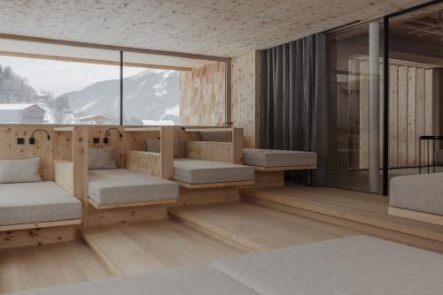 a room with benches and a large window at Hotel Marten - Ski-In & Ski-Out in Saalbach Hinterglemm