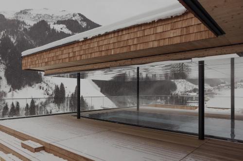 a building with a large window with a mountain view at Hotel Marten - Ski-In & Ski-Out in Saalbach Hinterglemm