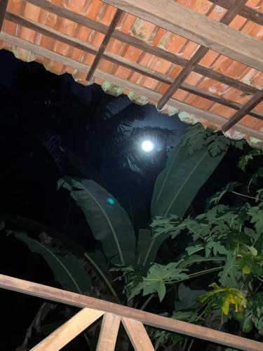 a view from under a pergola at night at Chalé Encantos do Una in Morros